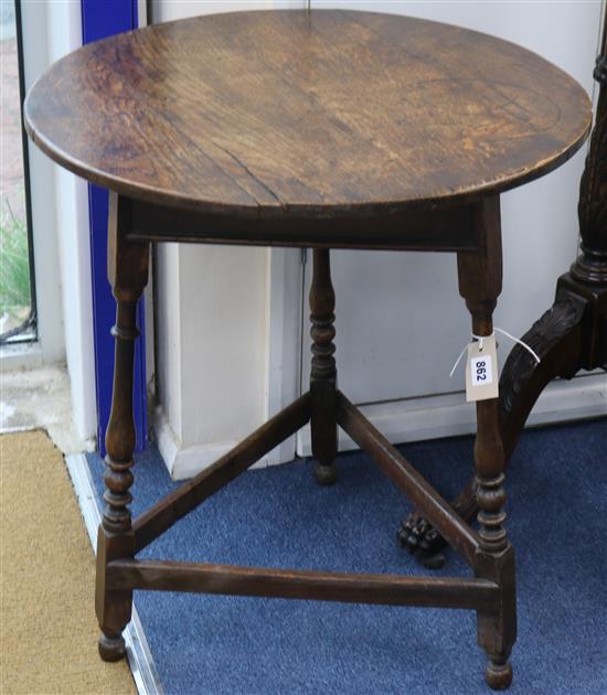 An 18th/19th century oak circular cricket table with secret drawer, 67cm high